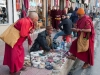 Monks at a sidewalk spice stall