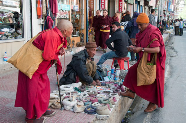 Monks at a sidewalk spice stall