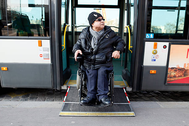 TO GO WITH AFP STORY BY ISABELLE TOURNE - Alain Ansellem, a disable person goes out of a bus on his wheelchair, on February 19, 2013 in Paris. French Prime Minister Jean-Marc Ayrault received on the first of March 1, 2013 from socialist senator Claire-Lise Campion a report on the accessibility of disabled people. AFP PHOTO KENZO TRIBOUILLARD        (Photo credit should read KENZO TRIBOUILLARD/AFP/Getty Images)